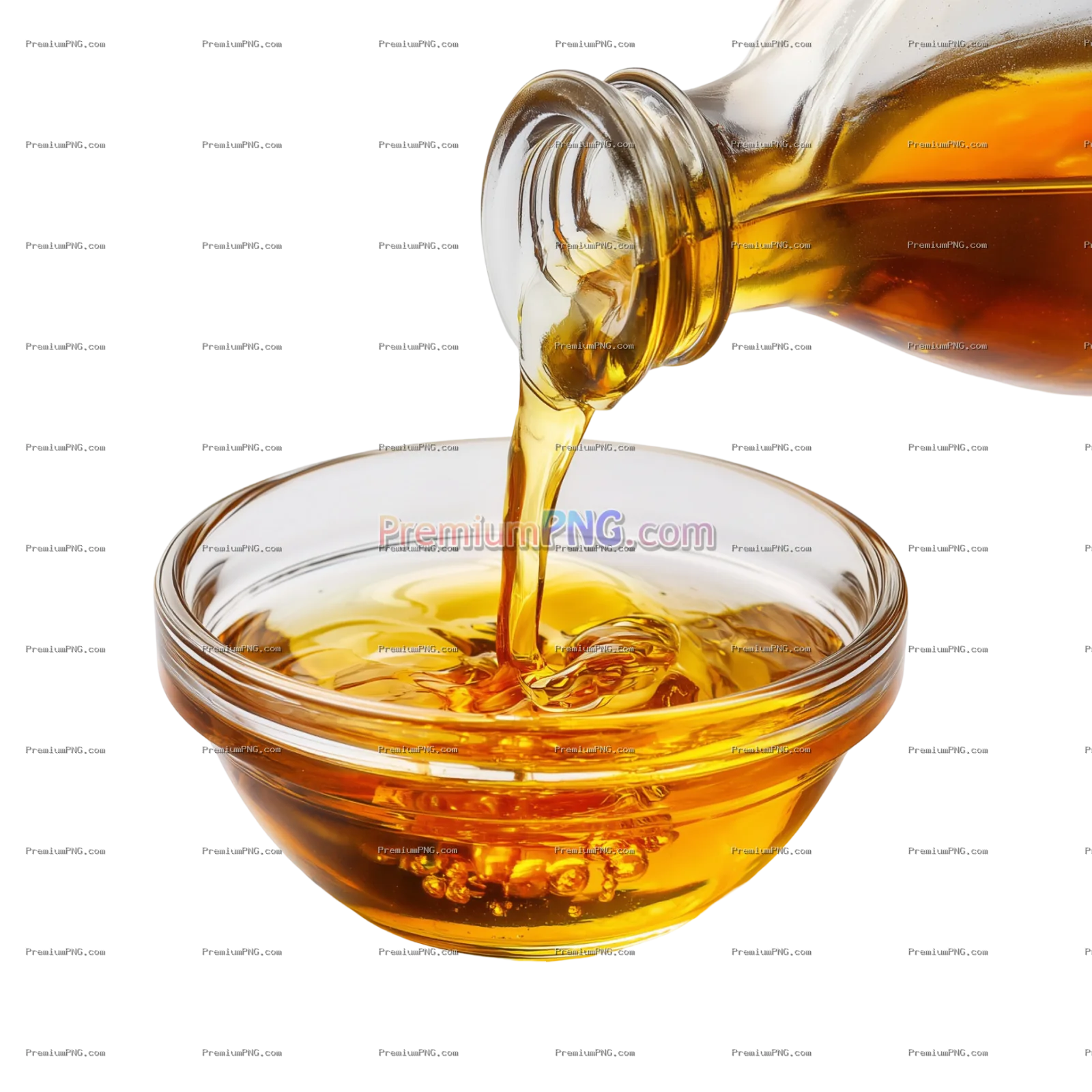 a glass bowl is filled with golden oil as it is being poured from a clear bottle