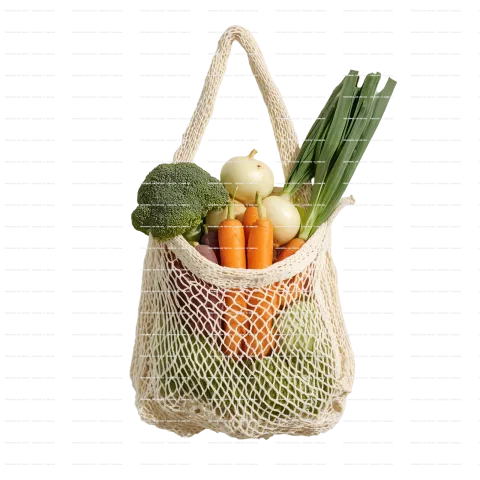cotton mesh bag filled with fresh vegetables in white background